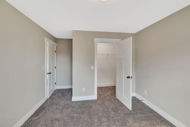 1071 Camden Trl, Greenbrier, TN 37073 - unfurnished bedroom with carpet flooring, a walk in closet, baseboards, and a closet