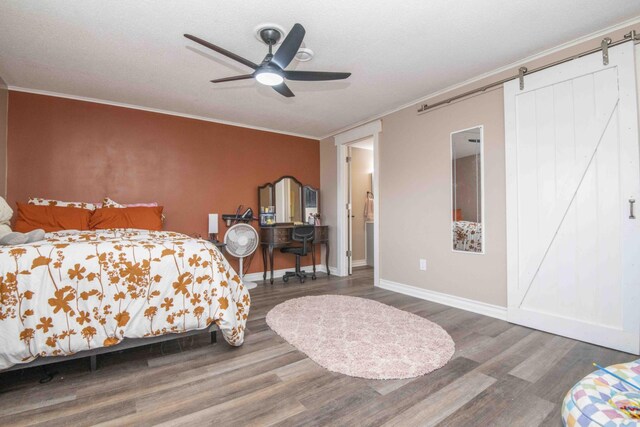 813 Stiner Ln, La Follette, TN 37766 - bedroom with a barn door, wood finished floors, crown molding, baseboards, and ceiling fan