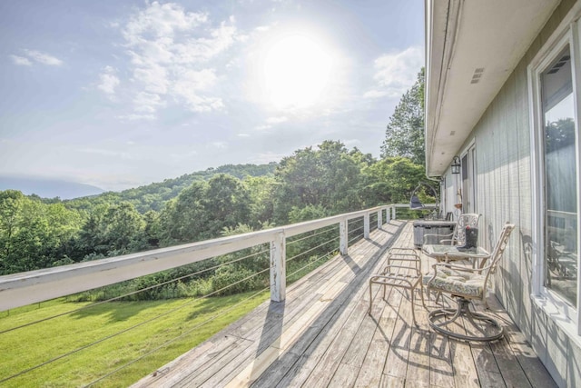 813 Stiner Ln, La Follette, TN 37766 - wooden deck featuring a view of trees and a lawn