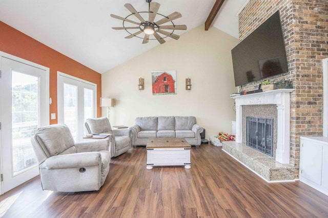 813 Stiner Ln, La Follette, TN 37766 - living room featuring a ceiling fan, wood finished floors, a fireplace with raised hearth, beam ceiling, and high vaulted ceiling