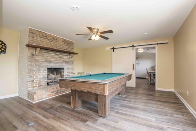 813 Stiner Ln, La Follette, TN 37766 - game room featuring a barn door, a ceiling fan, wood finished floors, and a fireplace