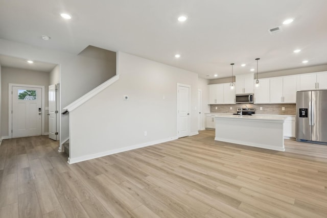 4232 Skyridge Dr, Nashville, TN 37207 - kitchen featuring appliances with stainless steel finishes, light countertops, recessed lighting, decorative backsplash, and white cabinetry