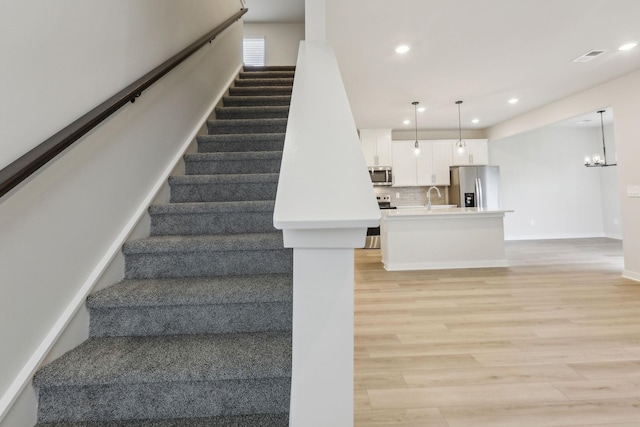 4232 Skyridge Dr, Nashville, TN 37207 - stairway with wood finished floors, recessed lighting, a chandelier, and baseboards