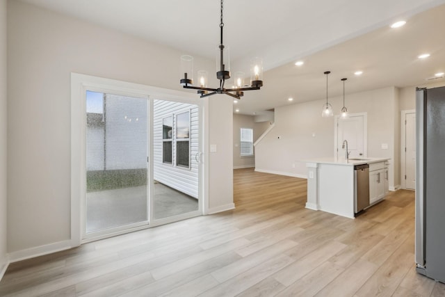4232 Skyridge Dr, Nashville, TN 37207 - kitchen featuring a chandelier, light wood-style flooring, appliances with stainless steel finishes, open floor plan, and a sink