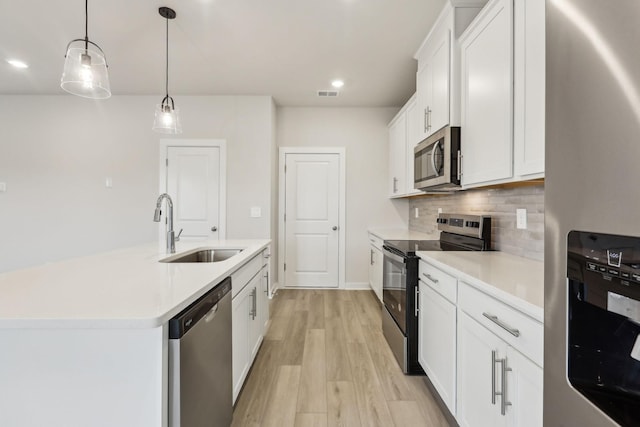 4232 Skyridge Dr, Nashville, TN 37207 - kitchen featuring stainless steel appliances, a sink, tasteful backsplash, light wood-style flooring, and light countertops
