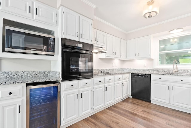 1409 Robert Ln, Cookeville, TN 38506 - kitchen featuring beverage cooler, black appliances, a sink, ornamental molding, and white cabinets