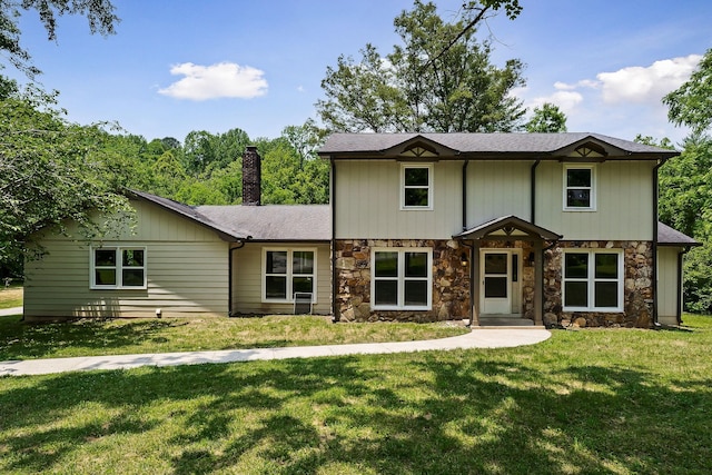 1409 Robert Ln, Cookeville, TN 38506 - view of front of house featuring stone siding, a chimney, a front yard, and a shingled roof