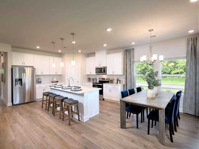 1343 Beasley Blvd, Mount Juliet, TN 37122 - kitchen featuring stainless steel appliances, an island with sink, decorative backsplash, light countertops, and recessed lighting