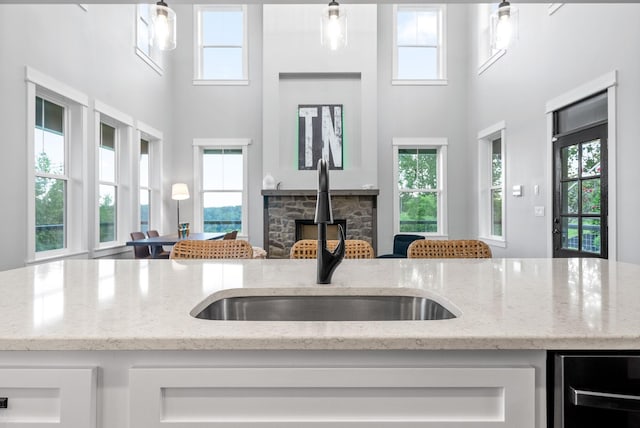 179 Deer Path Ct, Smithville, TN 37166 - kitchen featuring a sink, beverage cooler, plenty of natural light, white cabinets, and a high ceiling