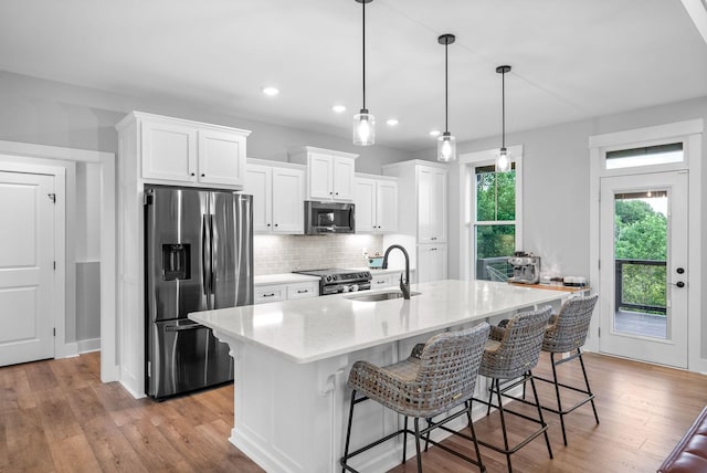 179 Deer Path Ct, Smithville, TN 37166 - kitchen featuring stainless steel appliances, a sink, decorative backsplash, white cabinetry, and recessed lighting