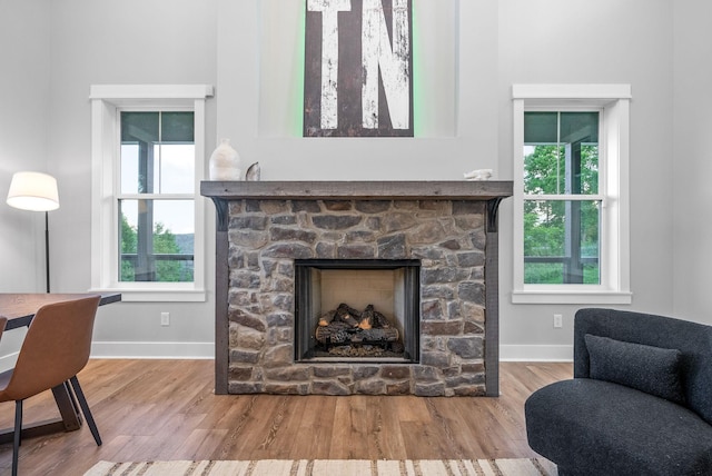 179 Deer Path Ct, Smithville, TN 37166 - living room with a stone fireplace, wood finished floors, and baseboards