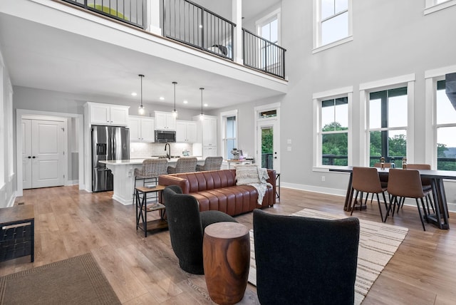 179 Deer Path Ct, Smithville, TN 37166 - living area with baseboards, recessed lighting, a towering ceiling, and light wood-style flooring
