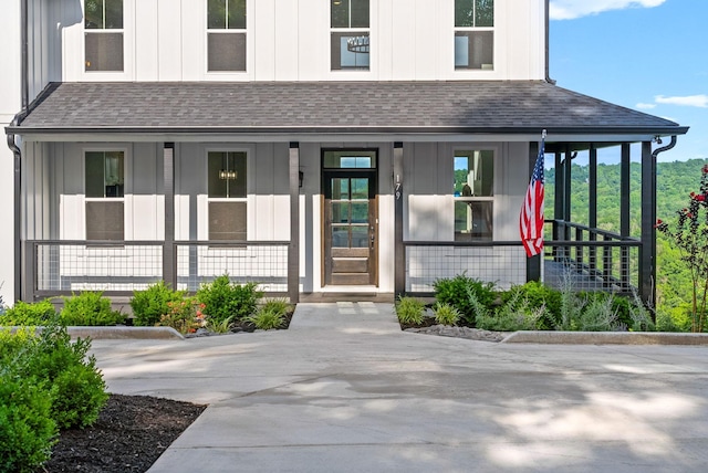 179 Deer Path Ct, Smithville, TN 37166 - doorway to property with board and batten siding, a porch, and roof with shingles