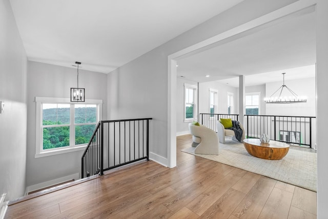 179 Deer Path Ct, Smithville, TN 37166 - corridor with a chandelier, wood-type flooring, an upstairs landing, and baseboards