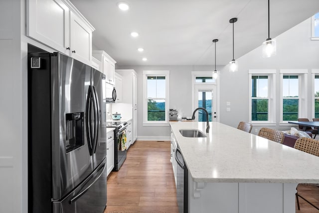 179 Deer Path Ct, Smithville, TN 37166 - kitchen featuring appliances with stainless steel finishes, a sink, an island with sink, light wood-style floors, and white cabinets