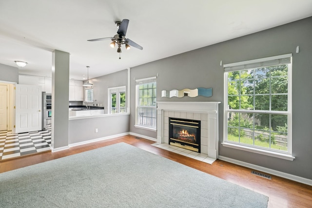 205 Caneel Cv, Hermitage, TN 37076 - unfurnished living room featuring healthy amount of natural light, ceiling fan, a fireplace, and wood finished floors