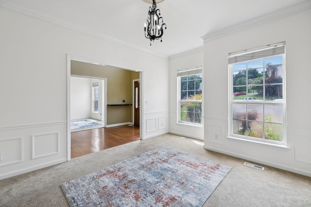 205 Caneel Cv, Hermitage, TN 37076 - spare room with carpet flooring, ornamental molding, a chandelier, and a wainscoted wall