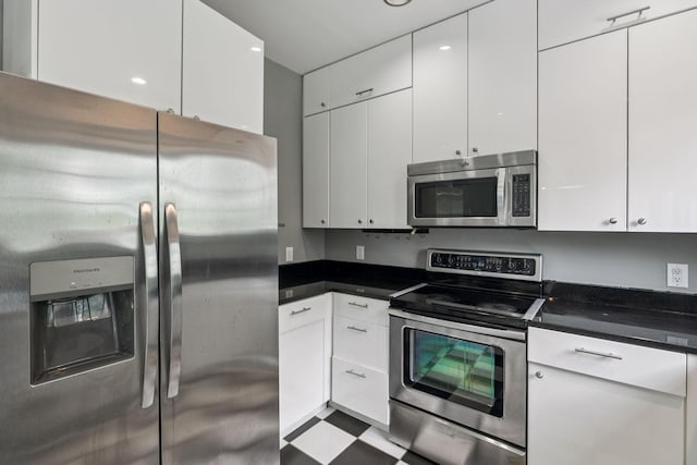 205 Caneel Cv, Hermitage, TN 37076 - kitchen featuring appliances with stainless steel finishes, white cabinets, dark countertops, and modern cabinets
