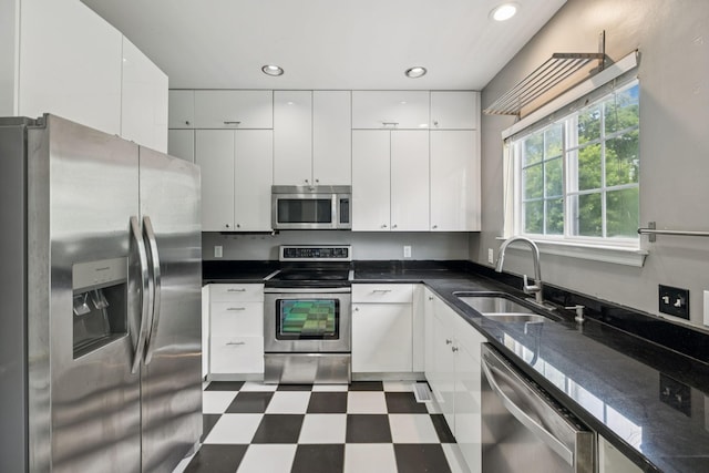 205 Caneel Cv, Hermitage, TN 37076 - kitchen with stainless steel appliances, a sink, tile patterned floors, white cabinets, and recessed lighting