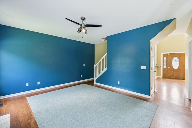 205 Caneel Cv, Hermitage, TN 37076 - empty room with wood finished floors, ceiling fan, baseboards, and stairway