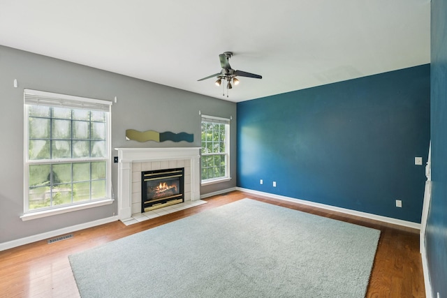 205 Caneel Cv, Hermitage, TN 37076 - unfurnished living room featuring a ceiling fan, baseboards, wood finished floors, and a tile fireplace
