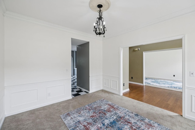 205 Caneel Cv, Hermitage, TN 37076 - spare room featuring carpet, ornamental molding, a chandelier, wainscoting, and a decorative wall