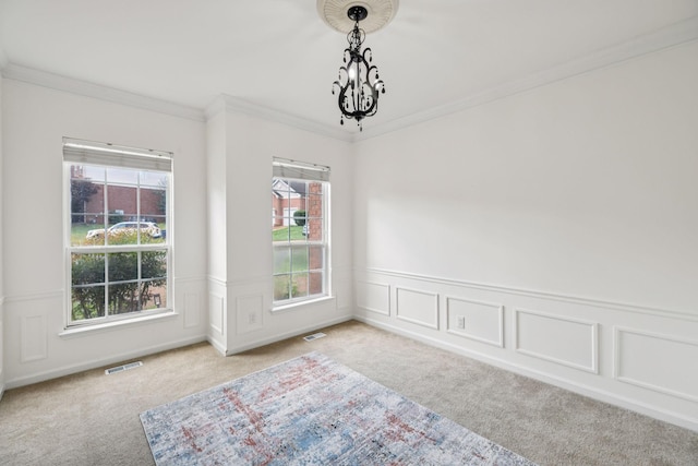 205 Caneel Cv, Hermitage, TN 37076 - spare room featuring light colored carpet, ornamental molding, a chandelier, and a wainscoted wall