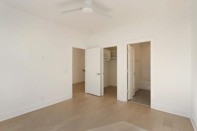 621 Live Life Ln, Nashville, TN 37207 - unfurnished bedroom with light wood finished floors, baseboards, a closet, and a spacious closet