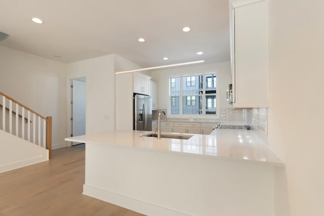 621 Live Life Ln, Nashville, TN 37207 - kitchen featuring stainless steel fridge, a sink, recessed lighting, a peninsula, and light wood-type flooring