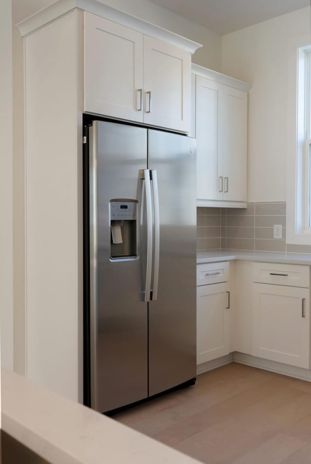 621 Live Life Ln, Nashville, TN 37207 - kitchen featuring stainless steel fridge with ice dispenser, light countertops, white cabinetry, backsplash, and light wood-style floors