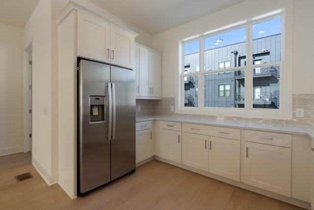 621 Live Life Ln, Nashville, TN 37207 - kitchen with stainless steel fridge with ice dispenser, light wood finished floors, decorative backsplash, and white cabinetry