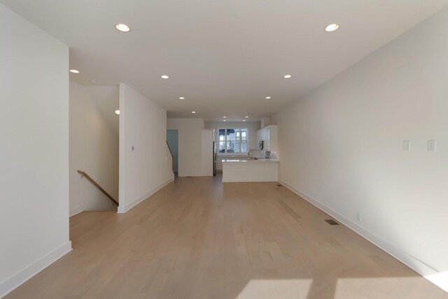 621 Live Life Ln, Nashville, TN 37207 - unfurnished living room featuring recessed lighting, baseboards, and light wood-type flooring