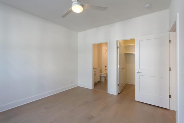 621 Live Life Ln, Nashville, TN 37207 - unfurnished bedroom featuring wood finished floors, a spacious closet, baseboards, and a closet