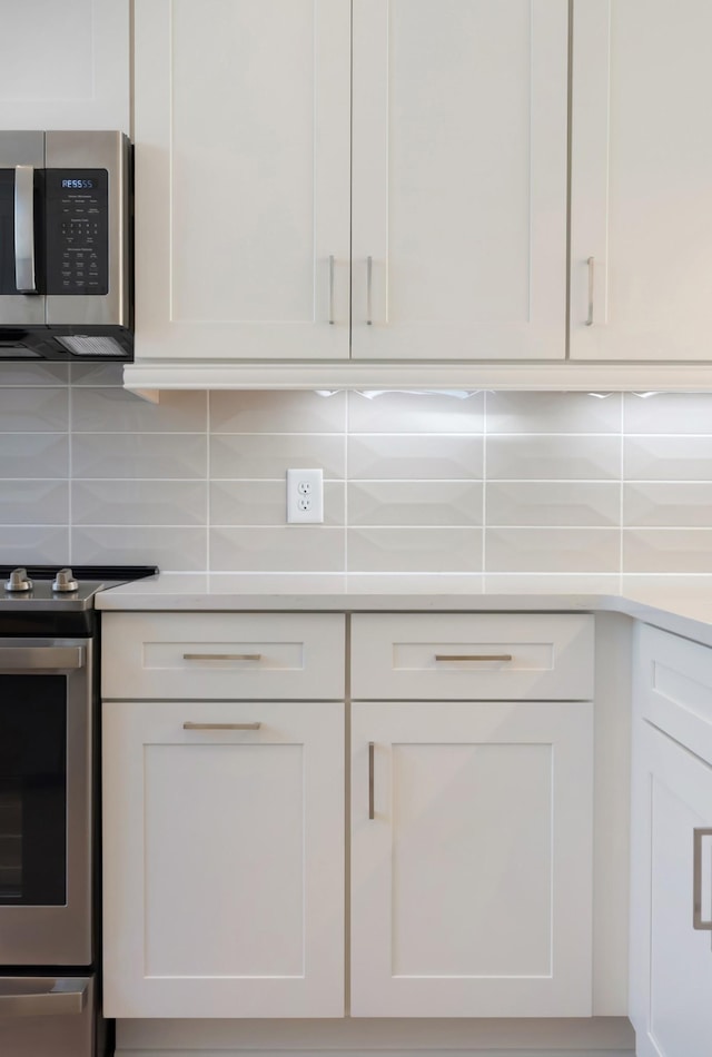 621 Live Life Ln, Nashville, TN 37207 - kitchen featuring appliances with stainless steel finishes, white cabinets, and backsplash