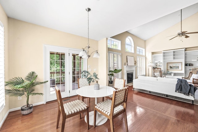8825 Caswick Ct, Nolensville, TN 37135 - dining room with wood finished floors, a chandelier, a glass covered fireplace, ceiling fan, and high vaulted ceiling