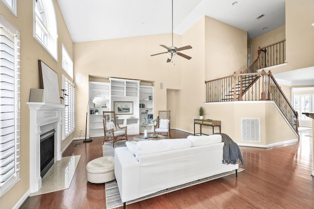 8825 Caswick Ct, Nolensville, TN 37135 - living room with a towering ceiling, stairway, wood finished floors, ceiling fan, and a premium fireplace