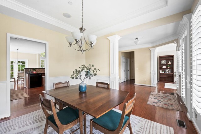 8825 Caswick Ct, Nolensville, TN 37135 - dining space with decorative columns, a chandelier, wainscoting, wood-type flooring, and ornamental molding