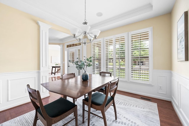 8825 Caswick Ct, Nolensville, TN 37135 - dining space with a chandelier, wainscoting, crown molding, dark wood-type flooring, and a decorative wall