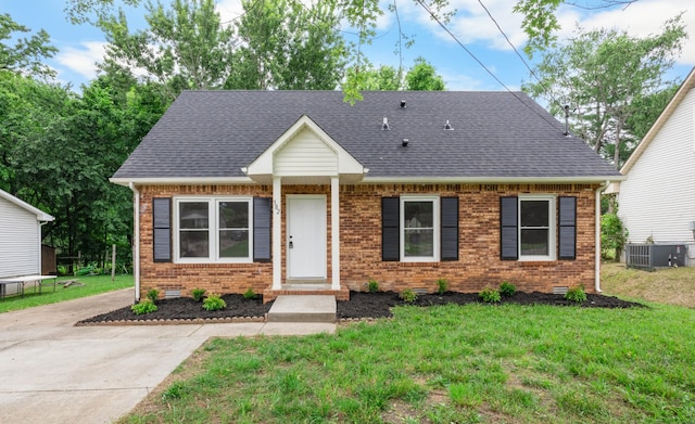 382 Louise Ln, Clarksville, TN 37042 - view of front of home with brick siding, central air condition unit, a front lawn, and a shingled roof