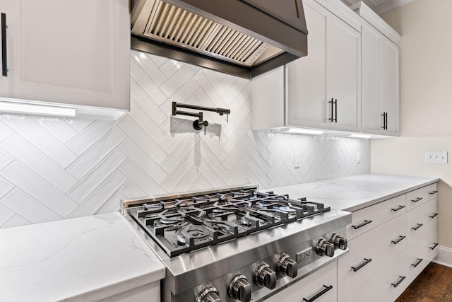 2006 Lynnhaven Ct, Mount Juliet, TN 37122 - kitchen with custom exhaust hood, stainless steel gas stovetop, backsplash, and light stone counters
