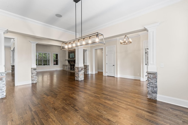 2006 Lynnhaven Ct, Mount Juliet, TN 37122 - unfurnished living room featuring decorative columns, a fireplace with raised hearth, wood finished floors, a chandelier, and ornamental molding