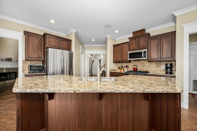 2245 Alexander Blvd, Murfreesboro, TN 37130 - kitchen with appliances with stainless steel finishes, a sink, decorative backsplash, dark tile patterned flooring, and a large island with sink