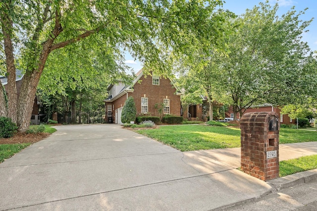 2245 Alexander Blvd, Murfreesboro, TN 37130 - view of property hidden behind natural elements with brick siding, concrete driveway, a front yard, and a garage