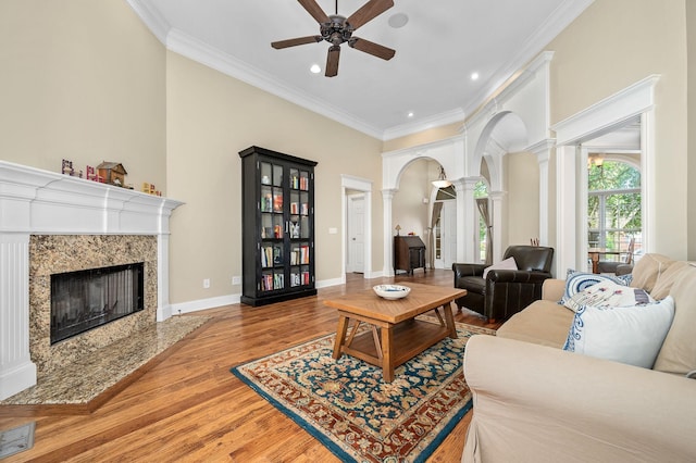 2245 Alexander Blvd, Murfreesboro, TN 37130 - living room with ornate columns, a high end fireplace, arched walkways, a ceiling fan, and wood finished floors