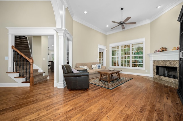 2245 Alexander Blvd, Murfreesboro, TN 37130 - living room with ceiling fan, light wood-style floors, a premium fireplace, stairway, and a high ceiling