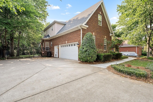 2245 Alexander Blvd, Murfreesboro, TN 37130 - view of side of home featuring brick siding, concrete driveway, roof with shingles, and a garage
