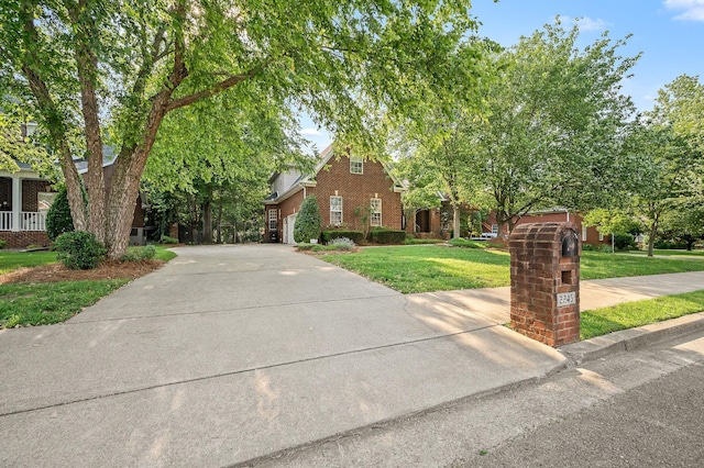 2245 Alexander Blvd, Murfreesboro, TN 37130 - view of property hidden behind natural elements featuring driveway, a front lawn, and brick siding