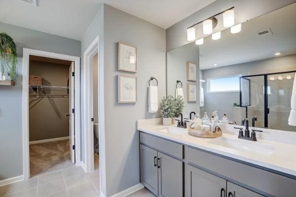 280 Subban Ct, Lebanon, TN 37087 - bathroom featuring double vanity, a shower stall, toilet, a spacious closet, and tile patterned floors
