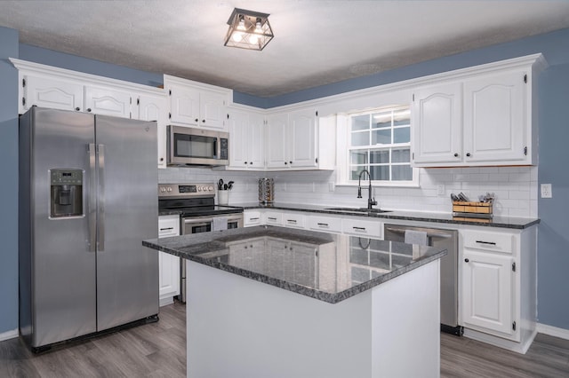 115 Pin Oaks Ln, Hohenwald, TN 38462 - kitchen with stainless steel appliances, a sink, dark wood-type flooring, white cabinets, and backsplash
