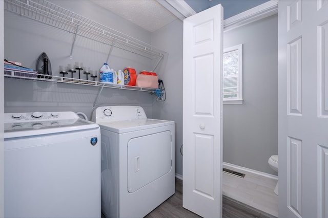 115 Pin Oaks Ln, Hohenwald, TN 38462 - laundry area featuring washer and dryer, dark wood-style floors, and baseboards